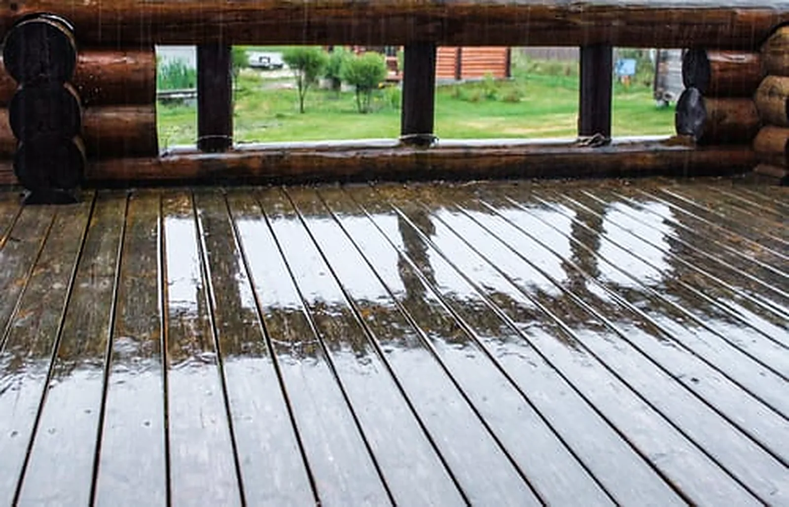 Rainwater pooling on a wood deck, showing why staining and sealing protect Bay Area decks through winter storms